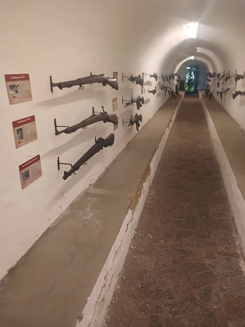 Túnel subterrâneo do Museu do Corpo de Fuzileiros Navais com armamentos históricos expostos nas paredes